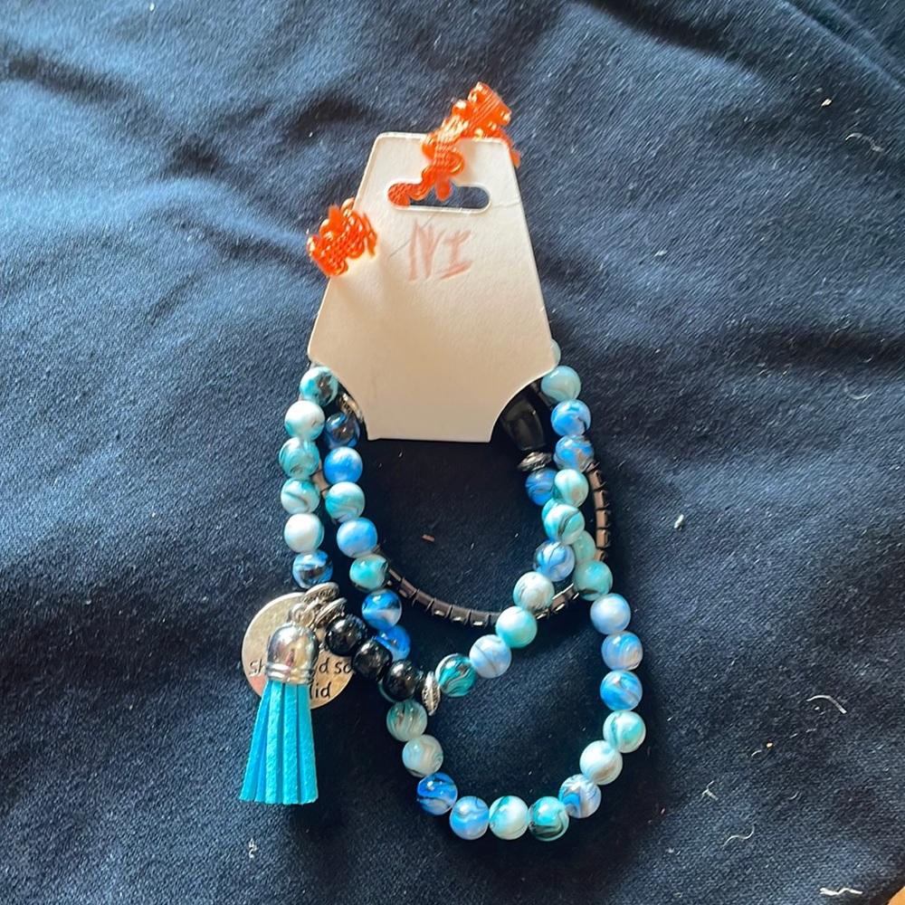 Set of three homemade bracelets with charms